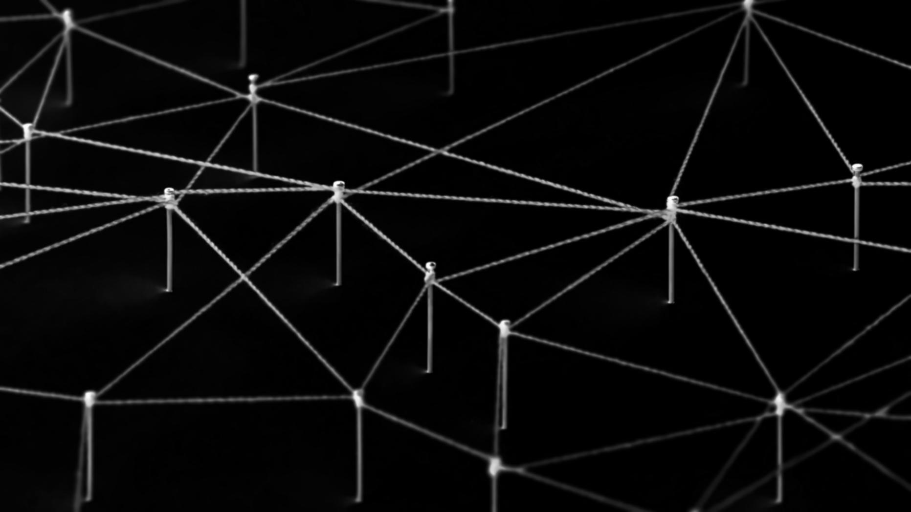 Group of blockchain developers discussing technical architecture and reviewing code on large displays